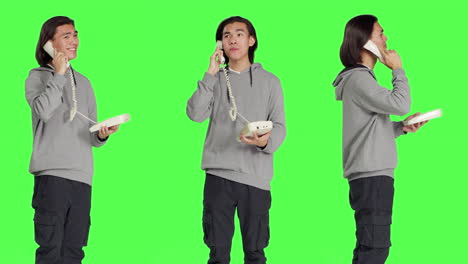 Asian-person-talking-on-landline-phone